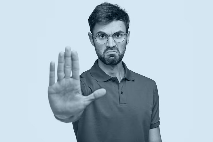 man gesturing stop, representing mistakes to avoid when link building