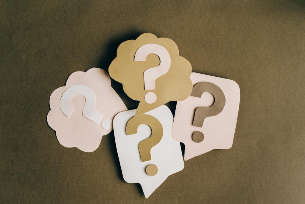 Four paper cutouts of question marks representing why adult backlinks matter