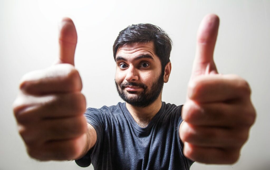 man doing thumbs up meant to represent what works for adult backlinks